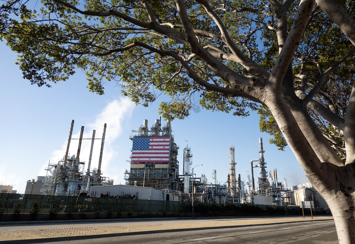 Marathon Petroleum Corporation's refinery in Carson, California displays an American flag with trees nearby