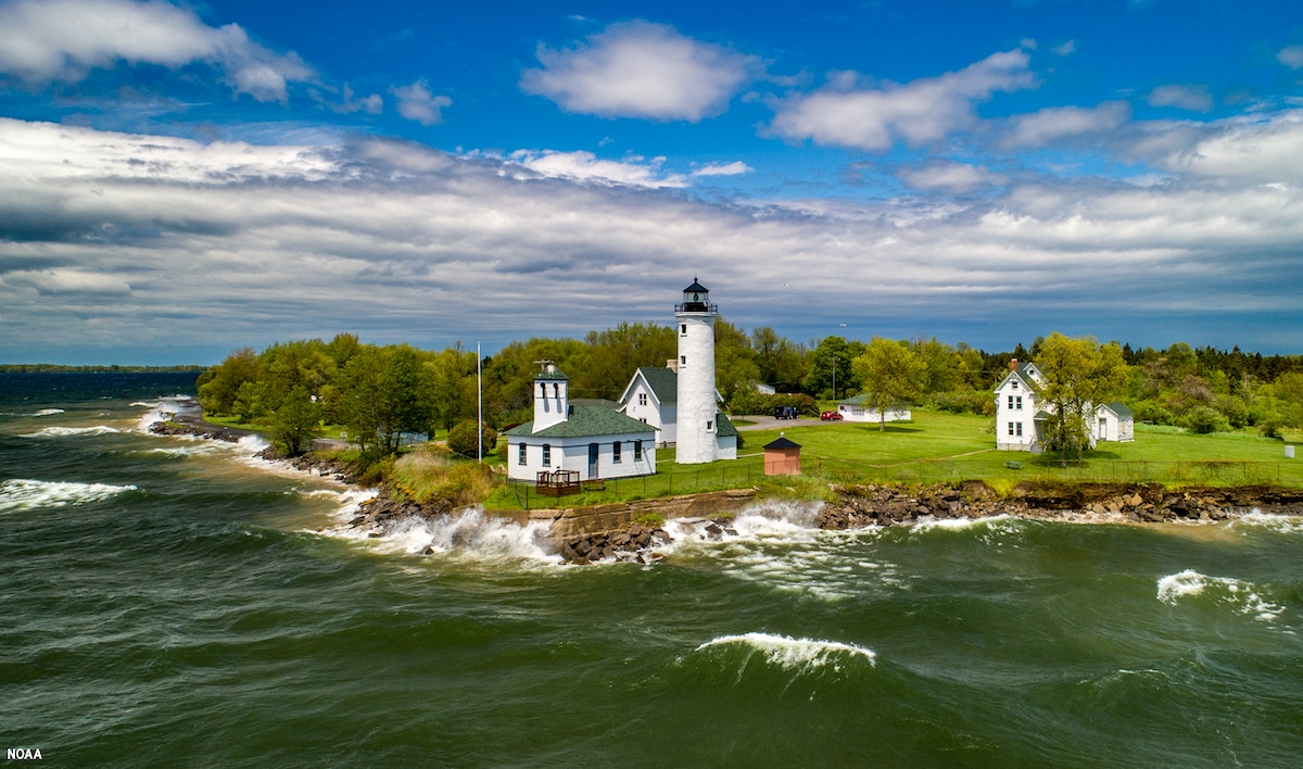 An aerial view of historic Tibbetts Point Lighthouse in the Town of Cape Vincent in Jefferson County, New York. The lighthouse marks the point where Lake Ontario meets the St. Lawrence River and overlooks the eastern boundary of Lake Ontario National Marine Sanctuary