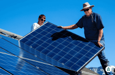 two men installing solar panels on the roof